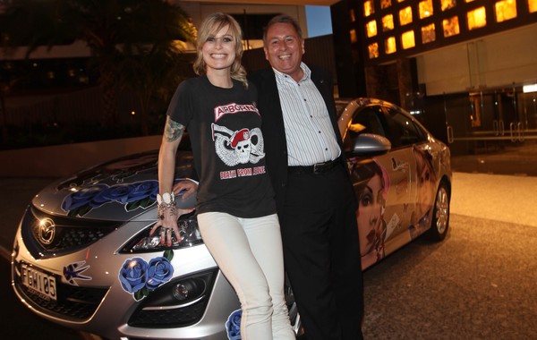 Mazda Best Female Solo Artist finalist Gin Wigmore with Andrew Clearwater, Managing Director Mazda New Zealand, alongside a custom designed Mazda6 featuring portraits of the artists by renowned tattoo artist Rose Hardy.